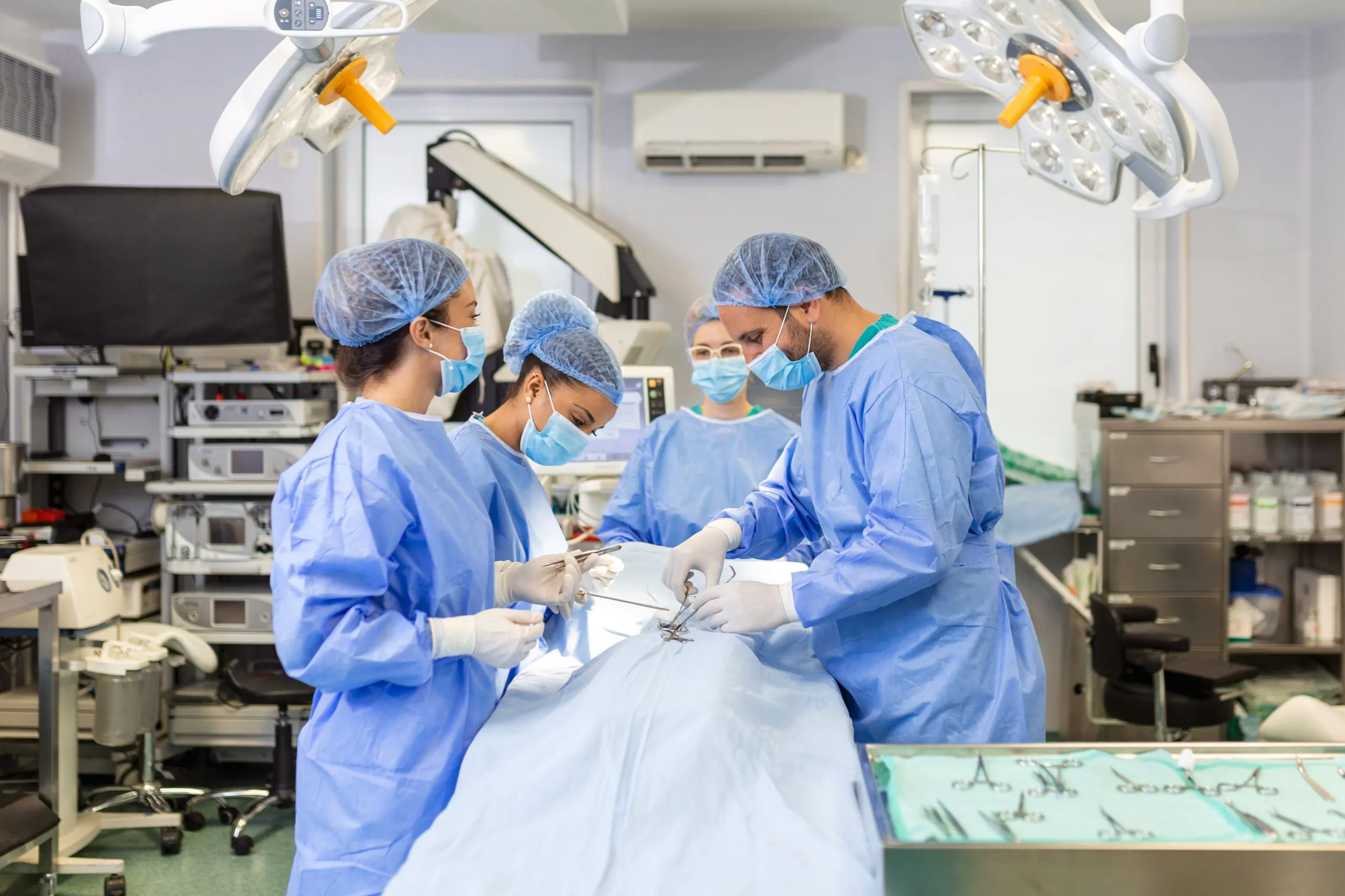 team-professional-doctors-performing-operation-surgery-room-medical-team-performing-surgical-operation-bright-modern-operating-room-min