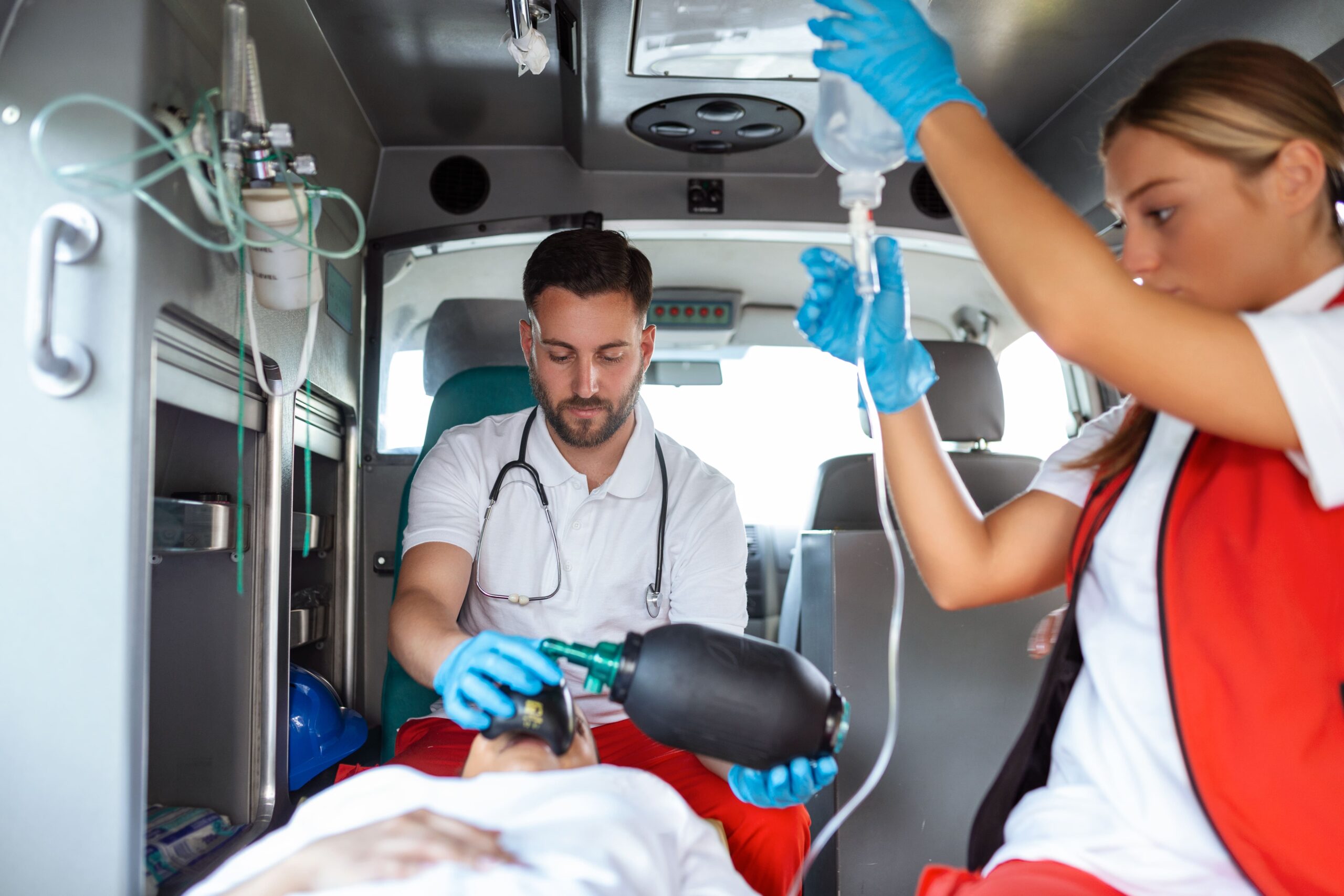 view-from-inside-ambulance-uniformed-emergency-services-workers-caring-patient-stretcher-during-coronavirus-pandemic-min